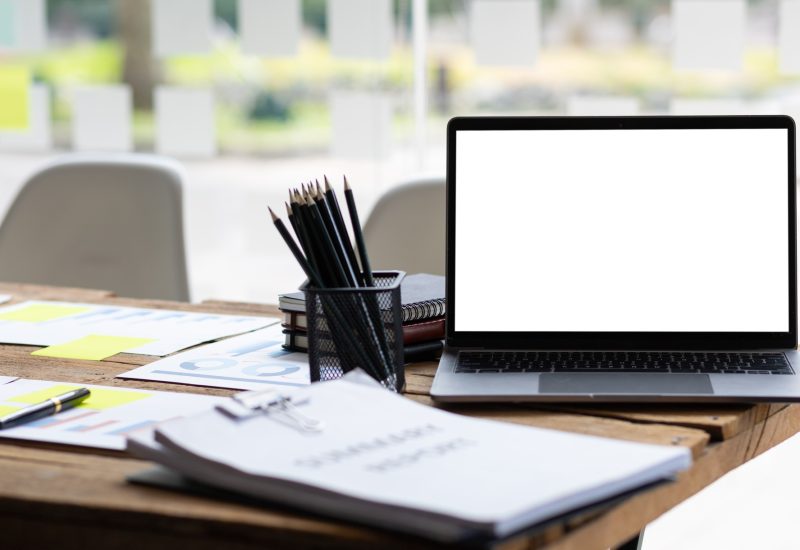 Laptop on desk and office equipment.